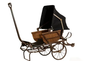 A baby carriage with a basket on top of it.